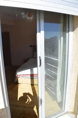 a sliding glass door leading to a bedroom with a bed at Appartement Laaz in Midelt