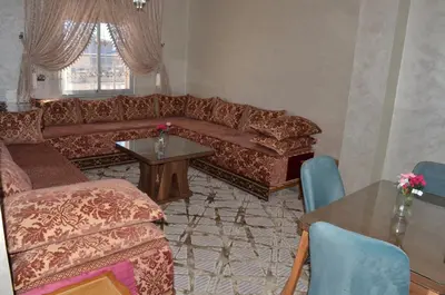 a living room with a couch and a table at Appartement Laaz in Midelt