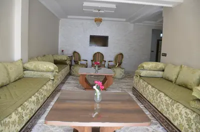 a living room with couches and a coffee table at Appartement Laaz in Midelt