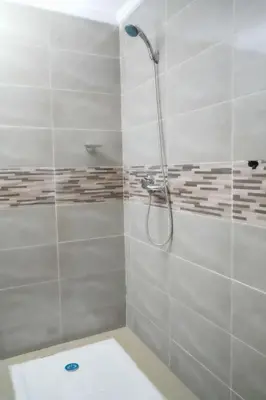 a bathroom with a shower with a glass door at Appartement Laaz in Midelt