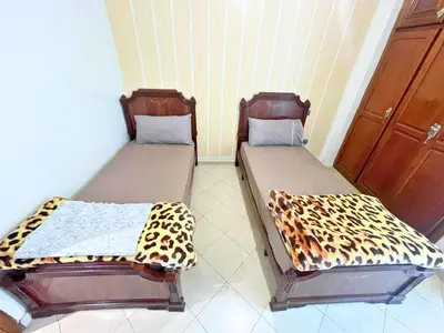 two beds sitting next to each other in a room at 2BR apartment - City Center Residency - Panoramic City Views - 3 Min Train Access by ZenStay in Fès