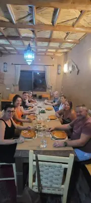 a group of people sitting around a long table at Dar fatima in Midelt