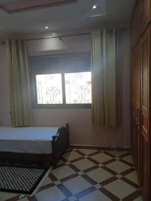 a bedroom with a bed and a window at Atlas stay in Fès