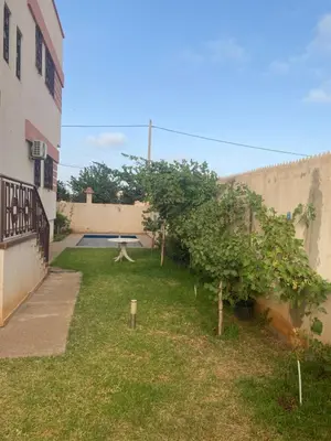 a courtyard with a picnic table in a yard at Atlas stay in Fès