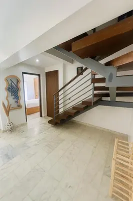 a staircase in a living room with a tile floor at Duplex 3 chambres - Piscine & Gym à 5 min du Carre Eden - Marrakech Center in Oulad Akkou
