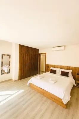 a large bedroom with a large white bed in it at Duplex 3 chambres - Piscine & Gym à 5 min du Carre Eden - Marrakech Center in Oulad Akkou