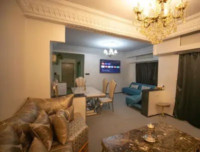 a living room with a couch and a dining room at Luxury Apartment in Fes New City Prime Location in Fès