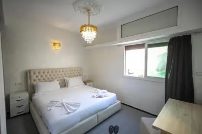 a bedroom with a white bed and a window at Luxury Apartment in Fes New City Prime Location in Fès