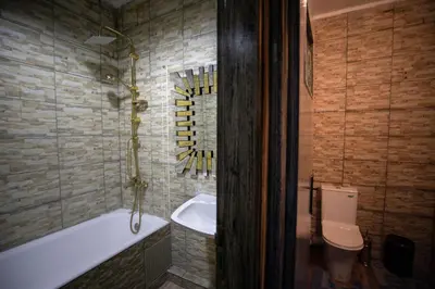 a bathroom with a bath tub and a toilet at Luxury Apartment in Fes New City Prime Location in Fès