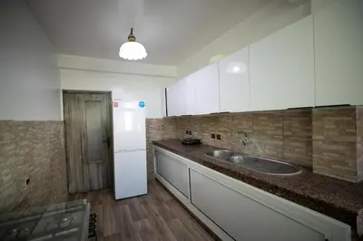 a kitchen with a sink and a refrigerator at Luxury Apartment in Fes New City Prime Location in Fès