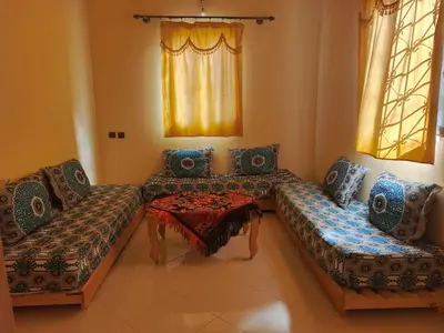 a living room with two couches and a table at Dar Bedda in Merzouga