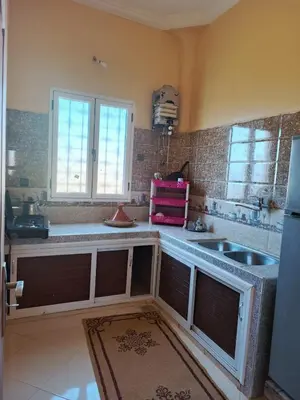 a kitchen with a sink and a counter top at Dar Bedda in Merzouga