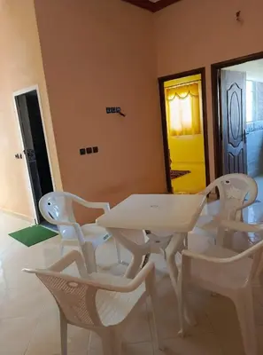 a white table and chairs in a room at Dar Bedda in Merzouga