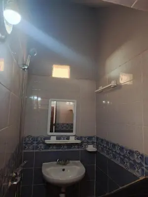 a bathroom with a sink and a mirror at Dar Bedda in Merzouga