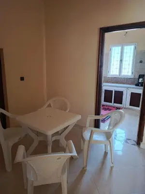 a table and chairs in a room with a window at Dar Bedda in Merzouga