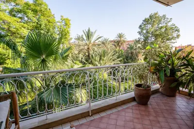 a balcony with palm trees and plants at Appartement de Luxe à Majorelle in Oulad Akkou