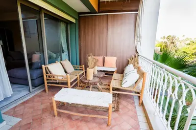 a balcony with chairs and a table on a porch at Appartement de Luxe à Majorelle in Oulad Akkou