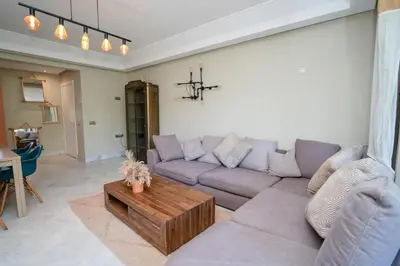a living room with a couch and a coffee table at Appartement de Luxe à Majorelle in Oulad Akkou