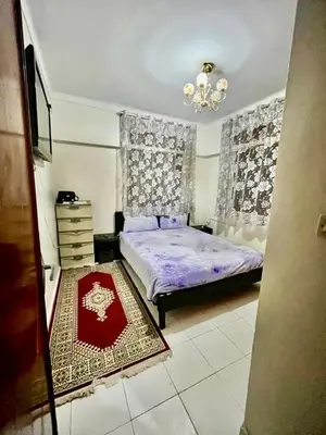 a bedroom with a bed and a chandelier at Superbe Joli studio indépendant pres de tout in Fès