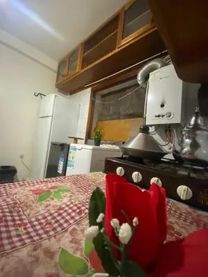 a kitchen with a red flower on a table at Superbe Joli studio indépendant pres de tout in Fès