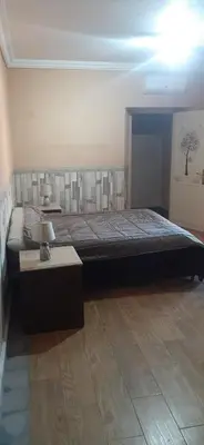 a bedroom with a large bed and a table at Villa Sidi Abdellah Ghiat in Chrabli