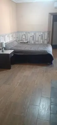 a bedroom with a bed and a wooden floor at Villa Sidi Abdellah Ghiat in Chrabli