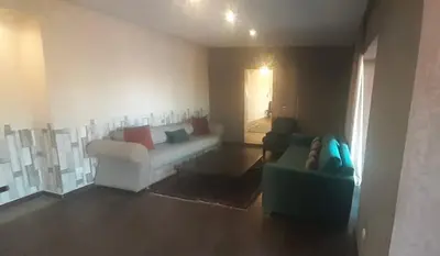 a living room with a couch and a chair at Villa Sidi Abdellah Ghiat in Chrabli