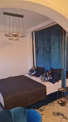 a bedroom with a large bed with blue walls at Appartement Fes in Fès