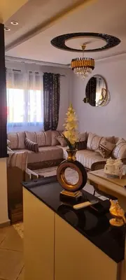 a living room with a couch and a table at Appartement Fes in Fès