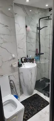 a bathroom with a toilet and a sink and a shower at Appartement Fes in Fès