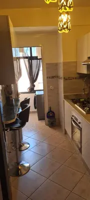 a kitchen with a table and chairs in a room at Appartement Fes in Fès