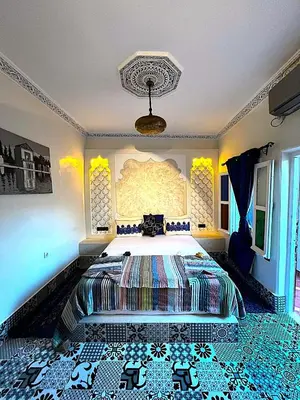 a bedroom with a large bed in a room at Riad haje skilf in Fès