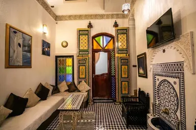 a living room with a couch and a fireplace at Riad haje skilf in Fès