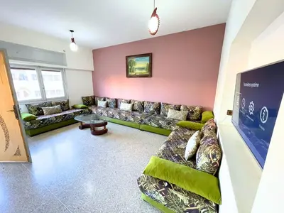 a large living room with couches and a table at 3Bed-Room City Centre Apartment - 3 min to Train Station in Fès