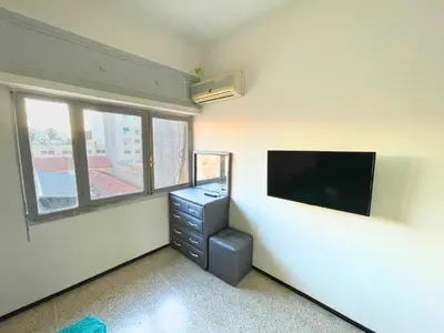 a room with a dresser and a flat screen tv at 3Bed-Room City Centre Apartment - 3 min to Train Station in Fès