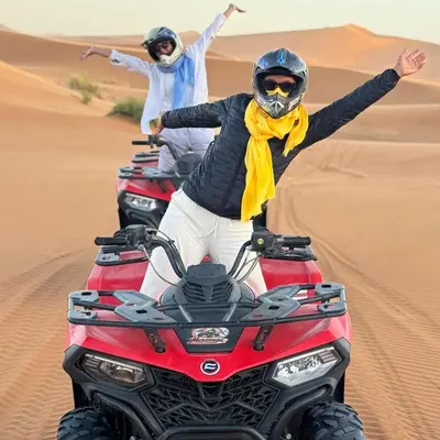 two people riding on motorcycles in the desert at Merzouga Explore Desert Camp in Merzouga