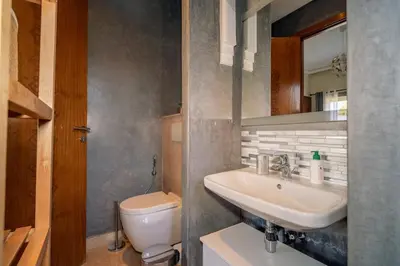 a bathroom with a sink and a toilet at Villa Yasmine Sun, Relaxation & Private Pool in Douar bel Rhanodour