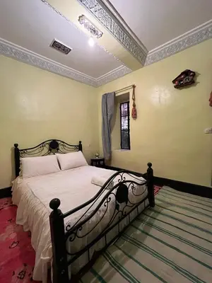 a bedroom with a large bed in a room at Palmas Magramane Ogandou in Skoura