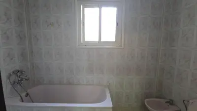a bathroom with a tub and a window and a sink at Meknès Cozy House by Yas in Meknès