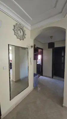 a room with a mirror and a clock on the wall at Meknès Cozy House by Yas in Meknès