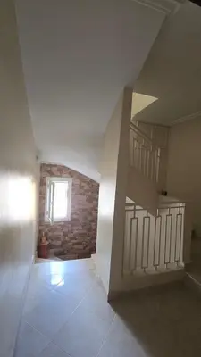 an empty room with a staircase and a brick wall at Meknès Cozy House by Yas in Meknès