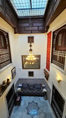 a living room with a couch and a chandelier at Dar Karaouyine Panoramic in Fès