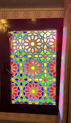 a stained glass window with a colorful pattern on a wall at Dar Karaouyine Panoramic in Fès