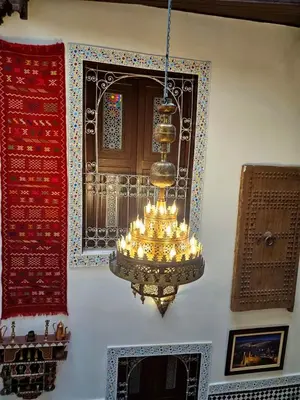 a chandelier hanging from a wall in a room at Dar Karaouyine Panoramic in Fès