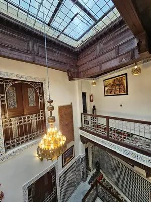 a chandelier hanging from the ceiling of a building at Dar Karaouyine Panoramic in Fès