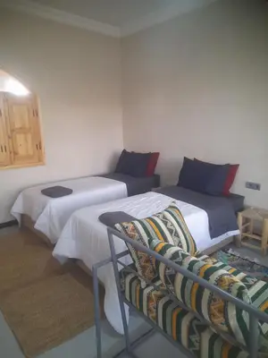 a room with two beds and a couch in it at Studio la petite Campagne Belgium Camp 50 km Near Marrakesh