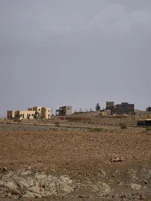 a view of a desert with buildings in the background at Studio la petite Campagne Belgium Camp 50 km Near Marrakesh