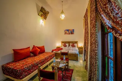 a living room with a couch and a bed at Riad Chams Fes in Fès