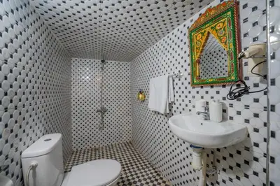a bathroom with a toilet and a sink and a mirror at Riad Chams Fes in Fès