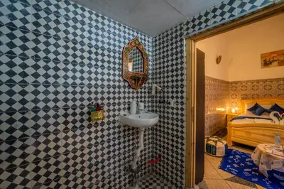 a bathroom with a sink and a bed at Riad Chams Fes in Fès